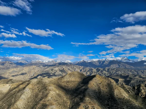Majestic mountains under a clear blue sky in Lo Manthang, Nepal