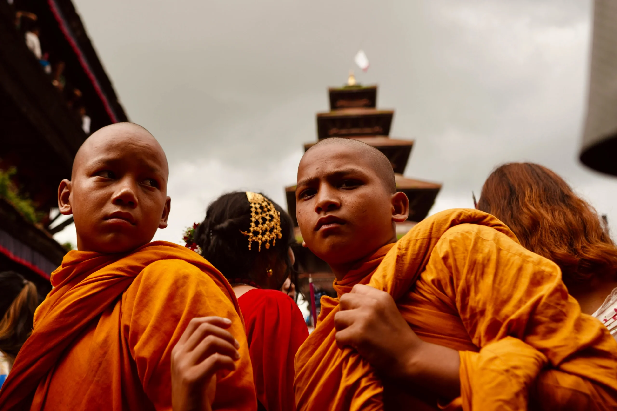 Nepali Buddhist monks in saffron robes participate in a vibrant cultural festival, capturing the essence of Nepal’s traditions